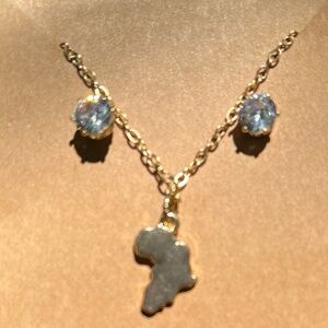 Small Africa continent charm on chain with pair of clear stone earrings